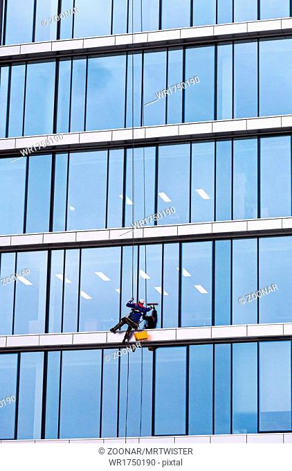 Window cleaner working on a glass facade