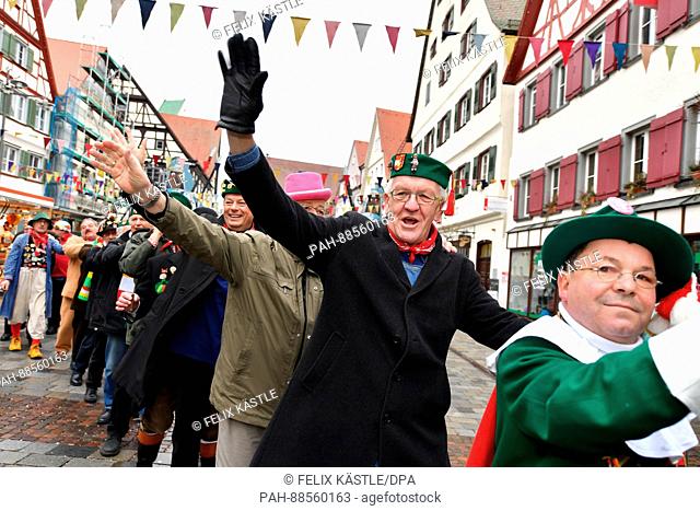 Prime Minister of Baden-Wuerttemberg Winfried Kretschmann (The Greens, 2.f.r.) can be seen dressed up in a jester costume during the Shrove Tuesday carnival...