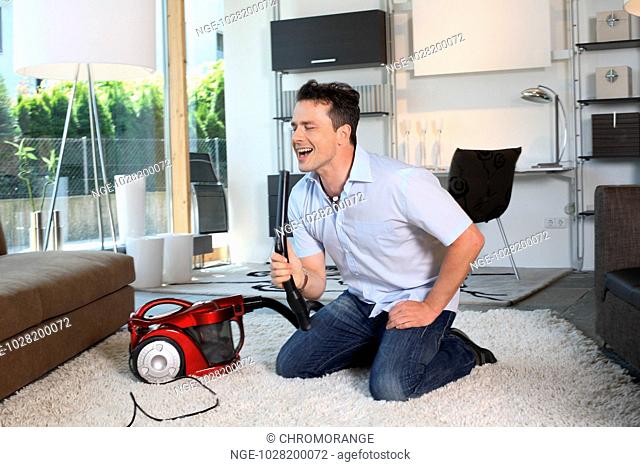 Man Twiddle with Vacuum Cleaner