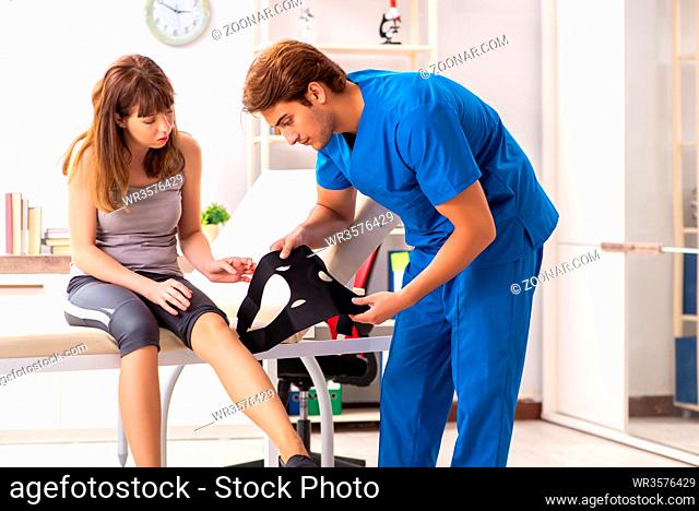 Young female patient visiting male doctor traumatologist