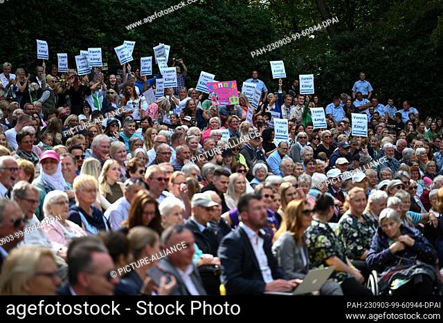 03 September 2023, Lower Saxony, Wiesmoor: Spectators support their favorites in the election of the blossom queen/king at the 71st Blossom Festival with...