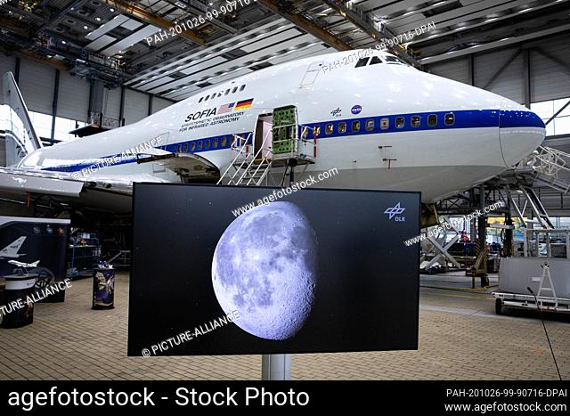 26 October 2020, Hamburg: At a press conference, a monitor showing a picture of the moon stands in front of the converted Boeing 747 with the Stratospheric...