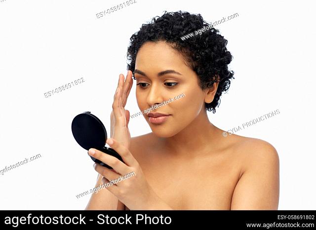 african american woman looking to mirror