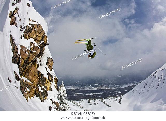 A male freeskier backflips in the Kicking Horse Backcountry, Golden, BC