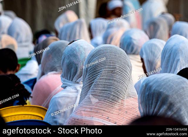 Ethiopian Orthodox women wearing white capes praying in Miskaye Hizunan Medhanealem church in Addis Ababa Ethiopia