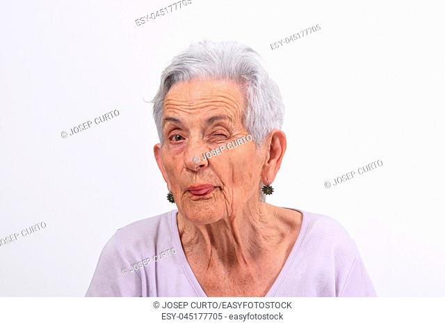 senior woman wink the eye on white background