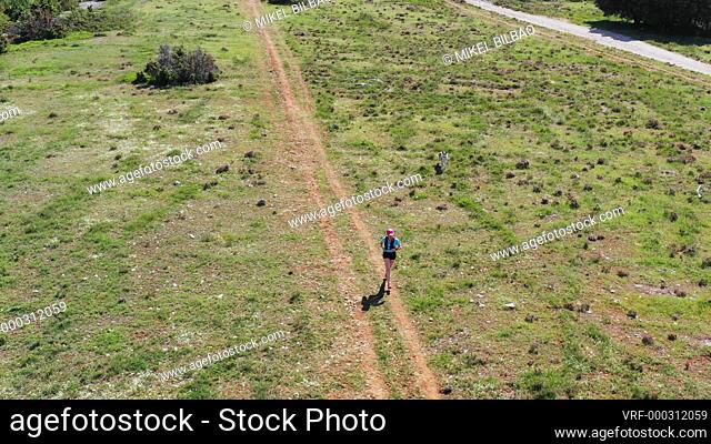 Runner woman outdoor. Navarre, Spain, Europe. Aerial view. 4K