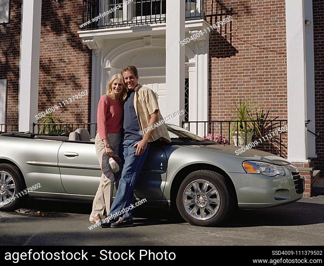 Couple leaning on convertible