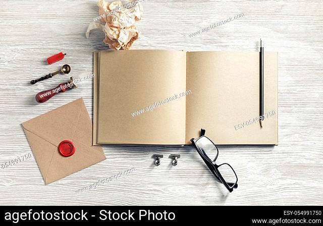 Blank sketchbook and retro stationery on light wooden background. Flat lay