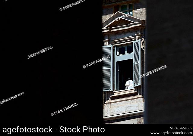 Pope Francis appears from the window of the Apostolic Palace in Saint Preter's Square. The square is empty due to the coronavirus pandemic