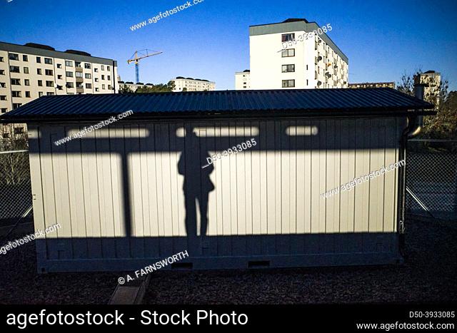 Stockholm, Sweden A man's shadow is projected onto a wall in the Bredang suburb subway or tunnelbana station