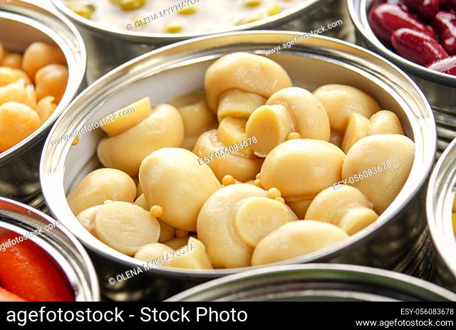 Canned button mushrooms in just opened tin can. Non-perishable food