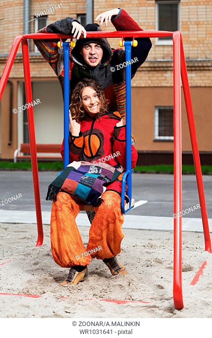 Happy young couple on the swing