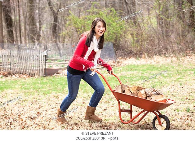 Girl pushing wheelbarrow