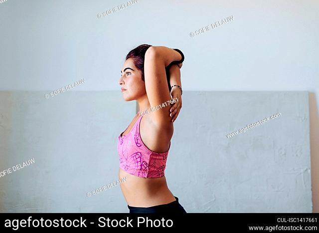 Woman doing stretching exercise at home