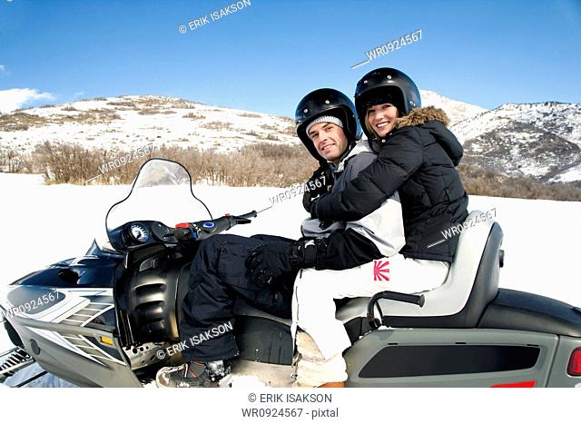 Couple on snow mobile