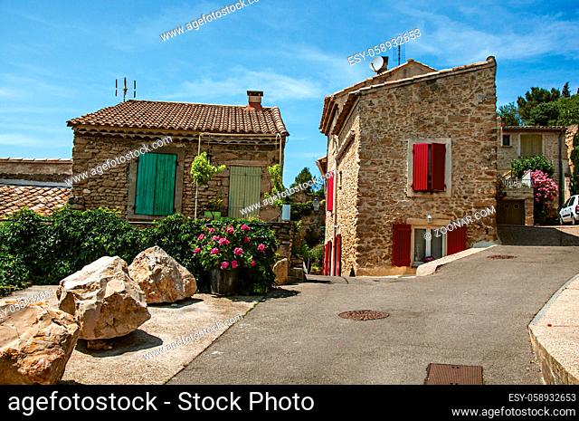 Street view with stone houses in the center of the village of Chateauneuf-du-Pape, blue sky and sunny day. Located in the Vaucluse department