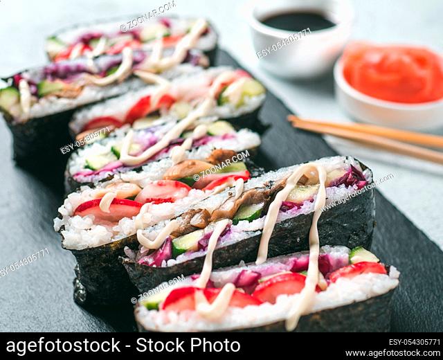 Vegan sushi sandwich onigirazu with vegetables. Healthy dinner recipe and idea. Colorful japan sandwich onigirazu with red cabbage, radish, cucumber, mushrooms