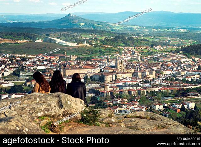 Group of people looking at Santiago de Compostela view from above on afternoon