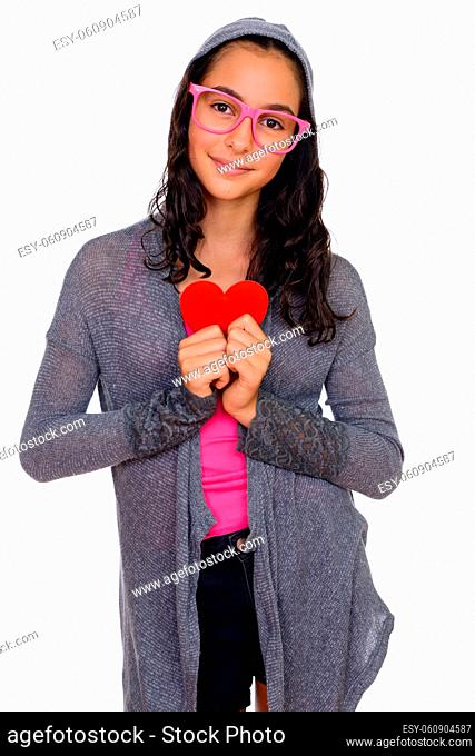 Studio shot of young beautiful teenage girl as nerd with eyeglasses isolated against white background