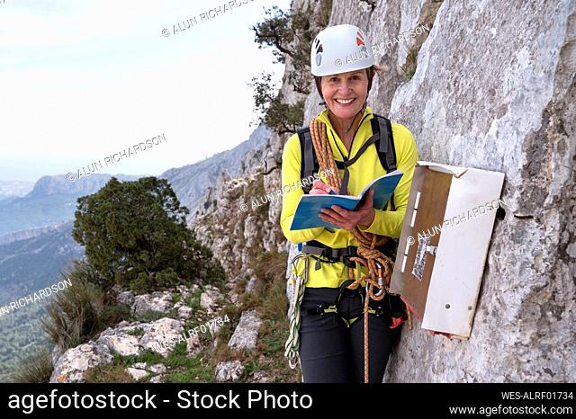 Portait of smiling mountaineer at Bernia Ridge, Costa Blanca, Alicante, Spain