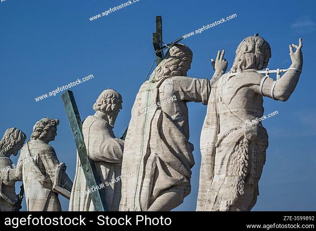 Rear-side view of statues above façade of St. Peter's Basilica featuring Christ the Redeemer and some of the apostles. St. Peter's Basilica. St