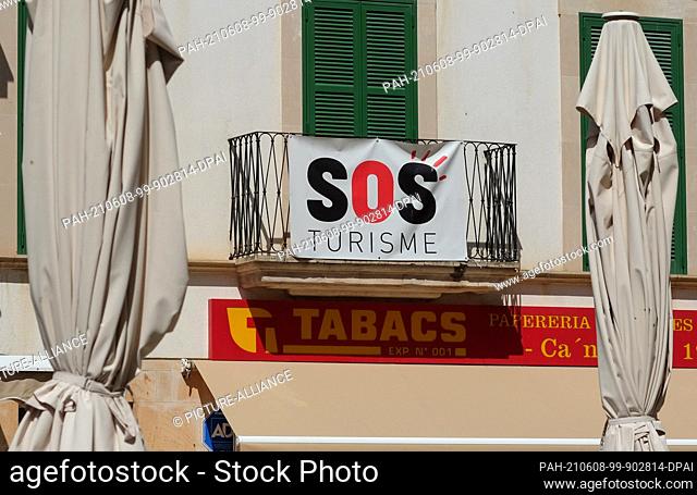 02 June 2021, Spain, Ses Salines: SOS Turisme is written on a poster in Ses Salines in the east of the island of Mallorca