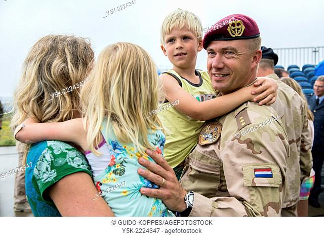 Eindhoven Airbase, Eindhoven, Netherlands. Airforce military employee welcomed home by his wife and two children after being deployed to Afghanistan for six...