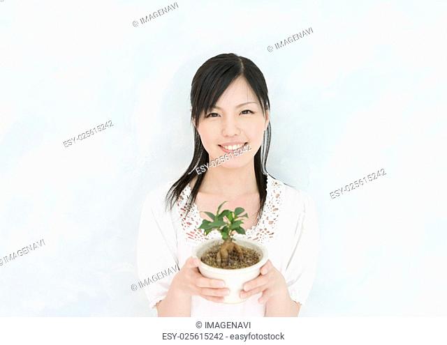 Woman Holding Potted Plant