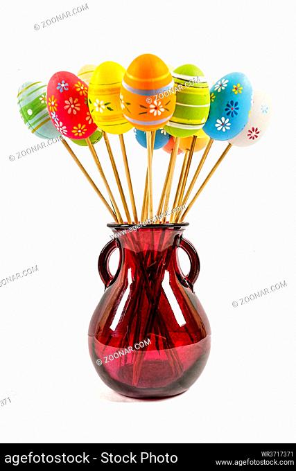 Creative bouquet of Easter items in a vase isolated on white background