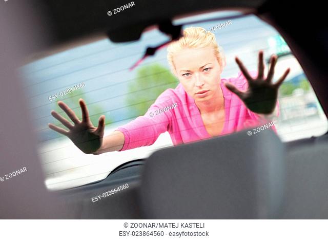 Woman pushing a car