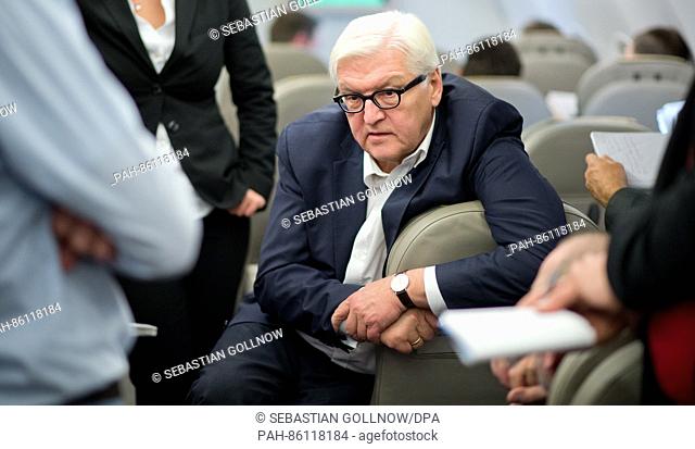The German Federal Foreign Minister Frank-Walter Steinmeier (M) speaks to journalists on his plane ride headed to Berlin after his meeting with the Foreign...