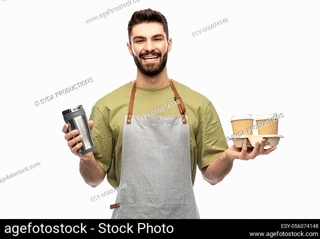 happy waiter with takeout coffee cups and tumbler
