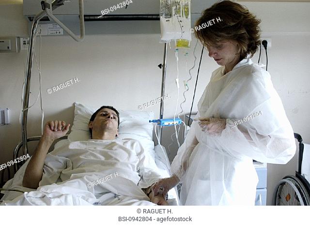 MAN HOSPITAL PATIENT W. NURSE<BR>Photo essay from hospital. Patient and nurse.<BR>Hospital of Reims, in the French region of Champagne-Ardenne