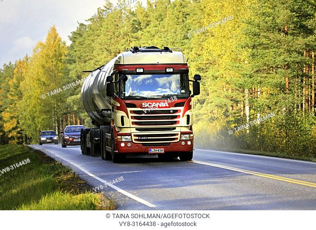 Salo, Finland - October 5, 2018: Colorful Scania R480 tank truck of R Danielsson Ky for bulk transport on autumnal highway through season's colours