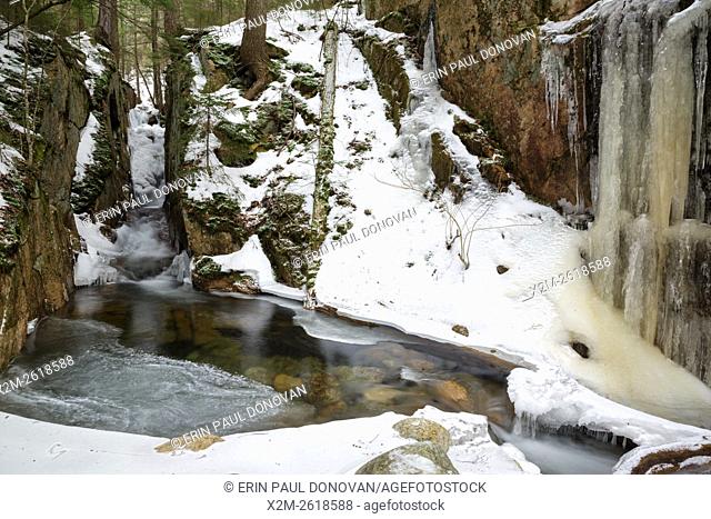 Small gorge along Cascade Brook in the Flume Gorge Scenic Area in Lincoln, New Hampshire USA during the winter months. This area is part of Franconia Notch...