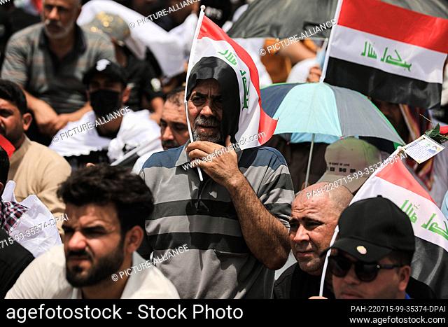 15 July 2022, Iraq, Baghdad: Followers of Iraqi Shia cleric Muqtada al-Sadr, leader of the Sadrist Movement, gather on the streets to perform the weekly Muslim...