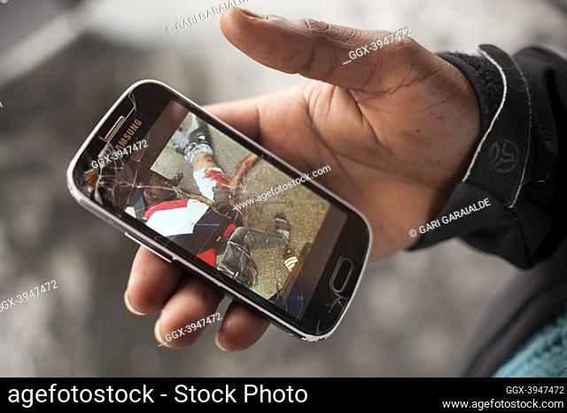 An African migrant shows a photo of a dead man on his smartphone, while he says this man was his friend. Irun (Spain). November 1, 2018