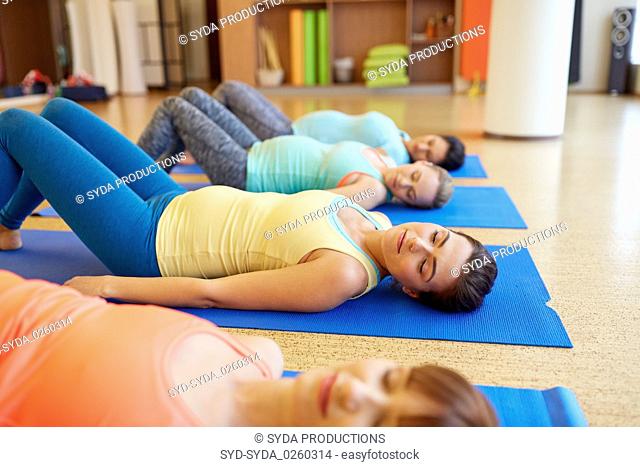 pregnant women lying on mats in gym