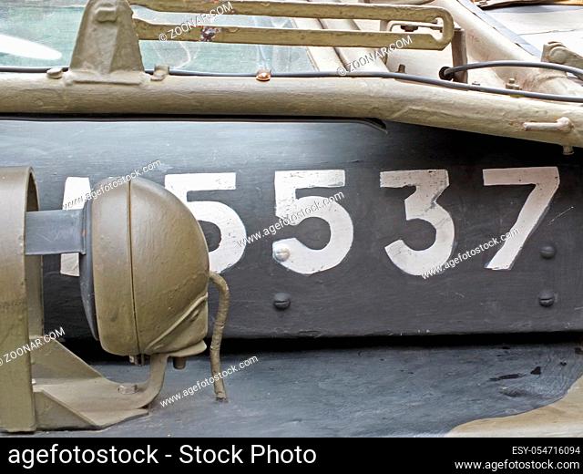 white numbers on the hood of a vintage American world war 2 vehicle with white letters and headlamp detail