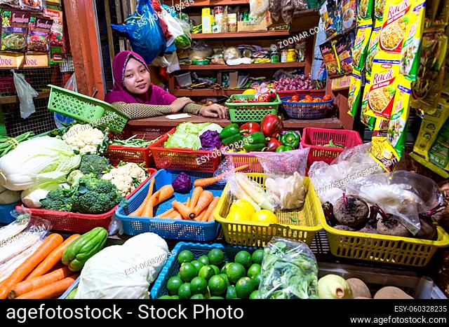 Surabaya, Indonesia - November, 05, 2017: Woman selling vegetables at the market in Surabaya in Indonesia