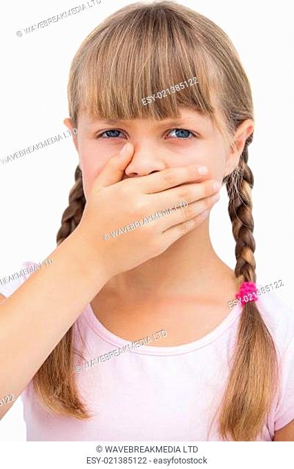 Little blond girl with her hand on her mouth on white background