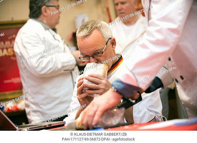 Michael Isensee (R), Stollen tester of the German Bread Institute, smells a butter stollen in Magdeburg, Germany, 27 November 2017