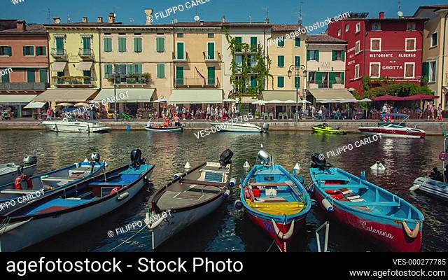 LAZISE, ITALY 16 SEPTEMBER 2020: Colored boats moored in Lazise on Garda Lake