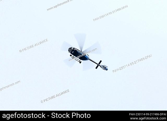 14 January 2023, Baden-Wuerttemberg, Freiburg im Breisgau: A police helicopter flies over the evacuated area before the start of a defusing of an aerial bomb
