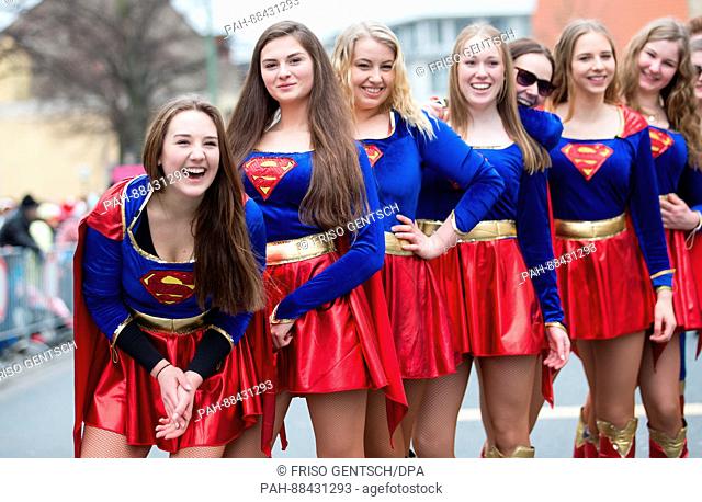 Carnival revelers dressed as supergirl celebrate during the traditional carnival parade in Osnabrueck, Germany, 25 February 2017