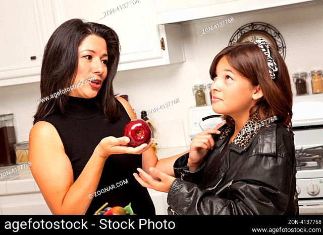 Pretty Hispanic Girl and Mother Getting Ready for School in the Kitchen