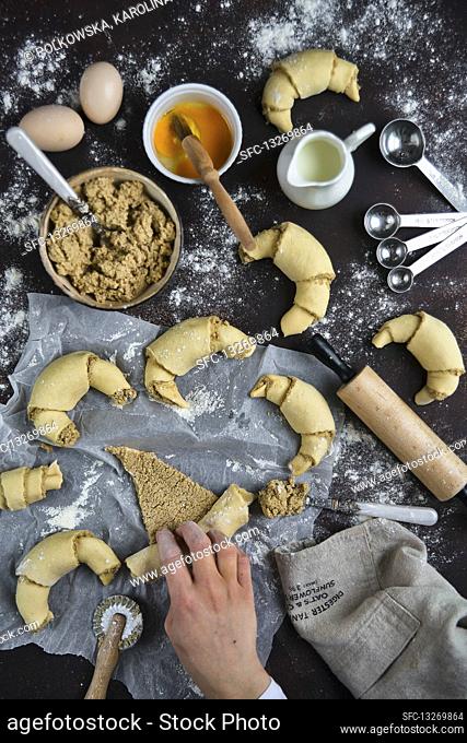 Preparation of croissants with white poppy seeds and almonds