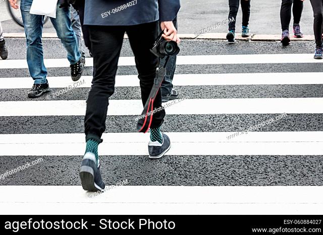 photographer at the pedestrian crossing in the city