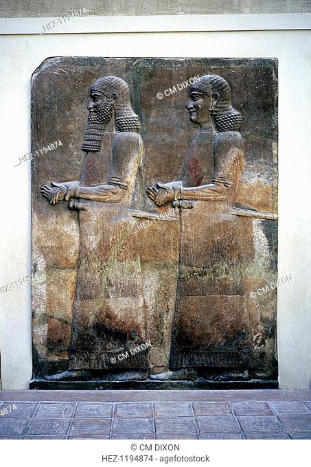 Assyrian relief of two servants, Palace of Sargon II, Khorsabad, c8th century BC. Part of the collection at The Louvre, Paris